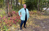 shannon posing outside among fall leaves and trees